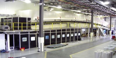 Doel Engineering coating line with an accumulator, a laminator, two turret unwinds, a turrent rewind, and a gas fired - four zone - air contra-flow - air impingement dryer