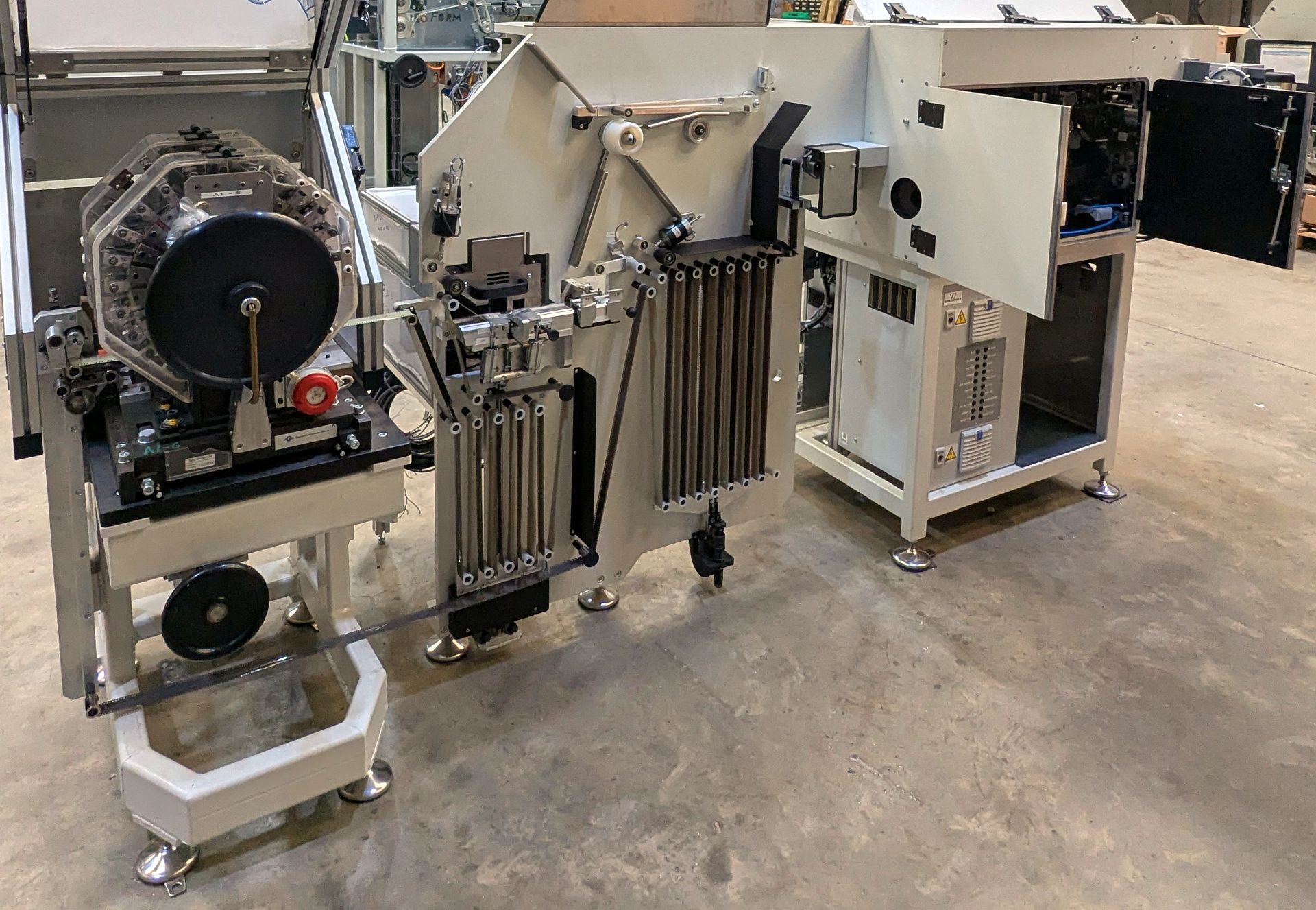 A dark room camera film notching and spooling machine. A dark room camera film notching and spooling machine.